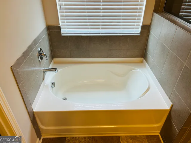 a bathroom with a bathtub and a shower