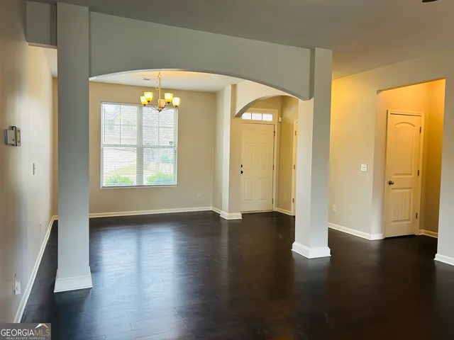an empty room with wooden floor and a window