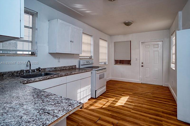3438 Southwest 2nd Street, Unit 3438 Miami, FL 33135 - Photo 13 of 15 a kitchen with wooden floors and a stove