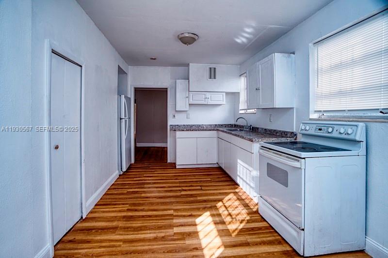 3438 Southwest 2nd Street, Unit 3438 Miami, FL 33135 - Photo 15 of 15 a kitchen with cabinets appliances and a window
