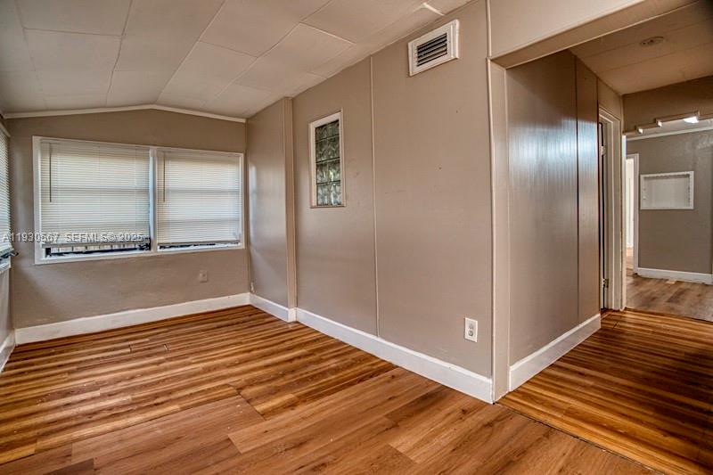 3438 Southwest 2nd Street, Unit 3438 Miami, FL 33135 - Photo 2 of 15 a view of a big room with wooden floor and windows