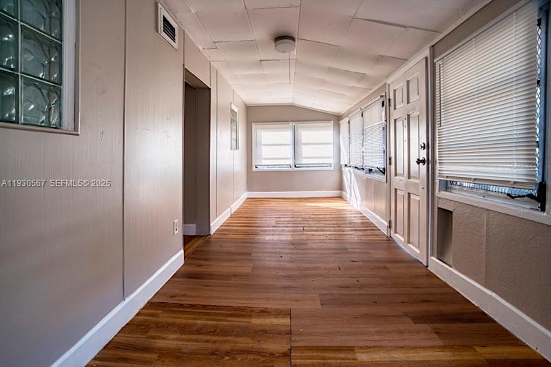 3438 Southwest 2nd Street, Unit 3438 Miami, FL 33135 - Photo 4 of 15 a view of a hallway with wooden floor and staircase
