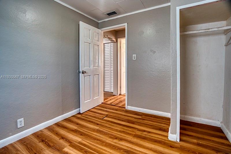 3438 Southwest 2nd Street, Unit 3438 Miami, FL 33135 - Photo 5 of 15 a view of a room with wooden floor and closet