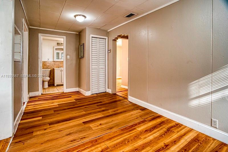 3438 Southwest 2nd Street, Unit 3438 Miami, FL 33135 - Photo 9 of 15 a view of an empty room with wooden floor and a window