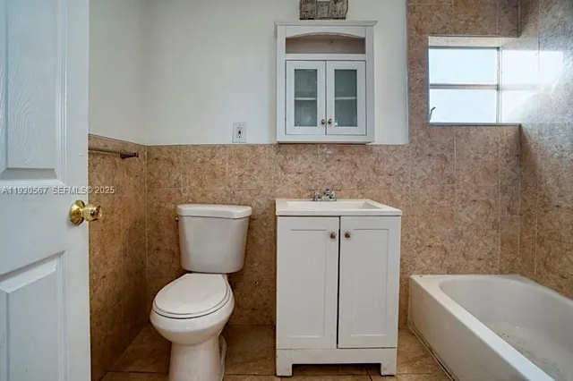 a bathroom with a sink toilet and bathtub