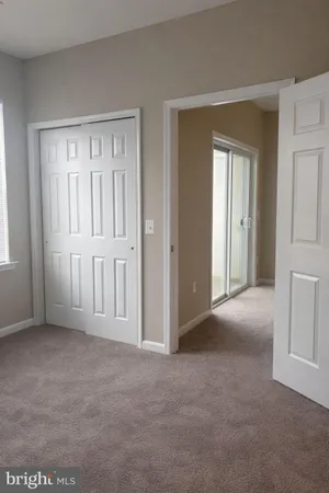 a view of an empty room with closet area
