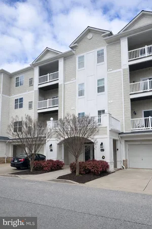 a front view of a building with parking