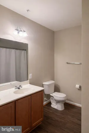 a bathroom with a sink toilet a mirror and vanity