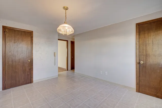 a view of an empty room with a chandelier