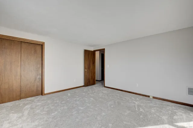a view of an empty room and closet area