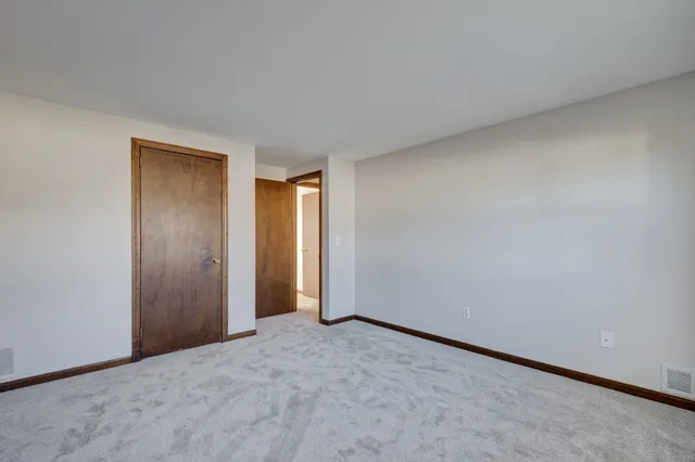an empty room with closet area