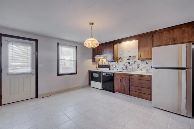a kitchen with a refrigerator and cabinets