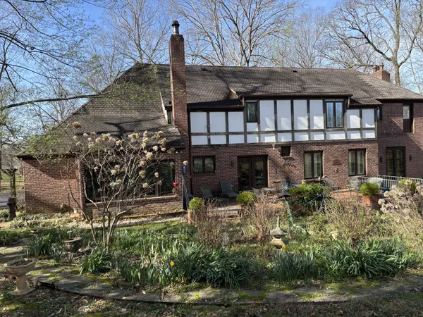 a front view of house with a garden