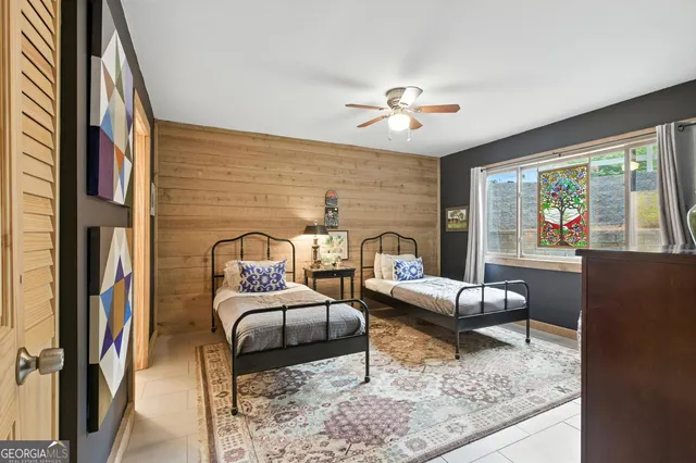 a bedroom with a bed dresser and a window