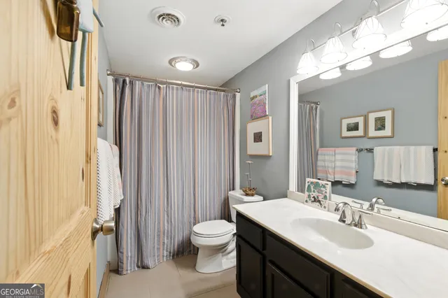 a bedroom with a bed wooden floor and window