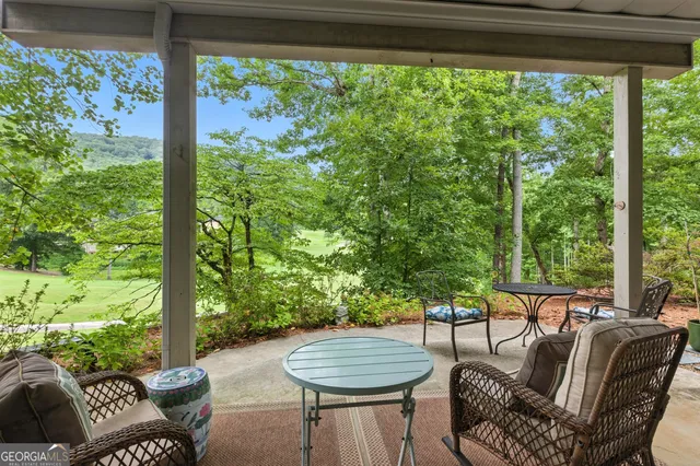 a building outdoor space with patio furniture and potted plants