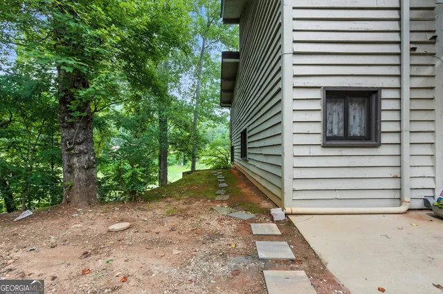 a view of a swimming pool with a lawn chairs and a fire pit