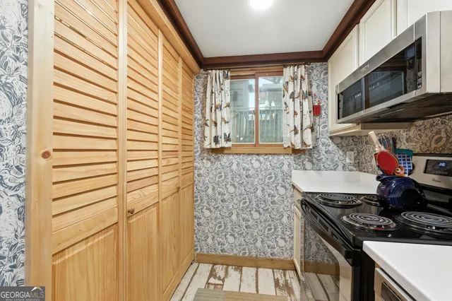 a kitchen with a sink stove and cabinets