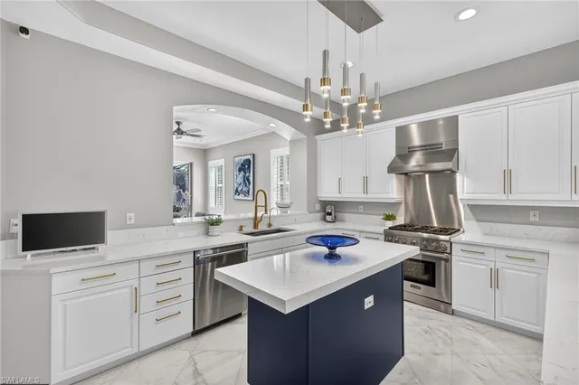 a kitchen with a sink a stove and cabinets