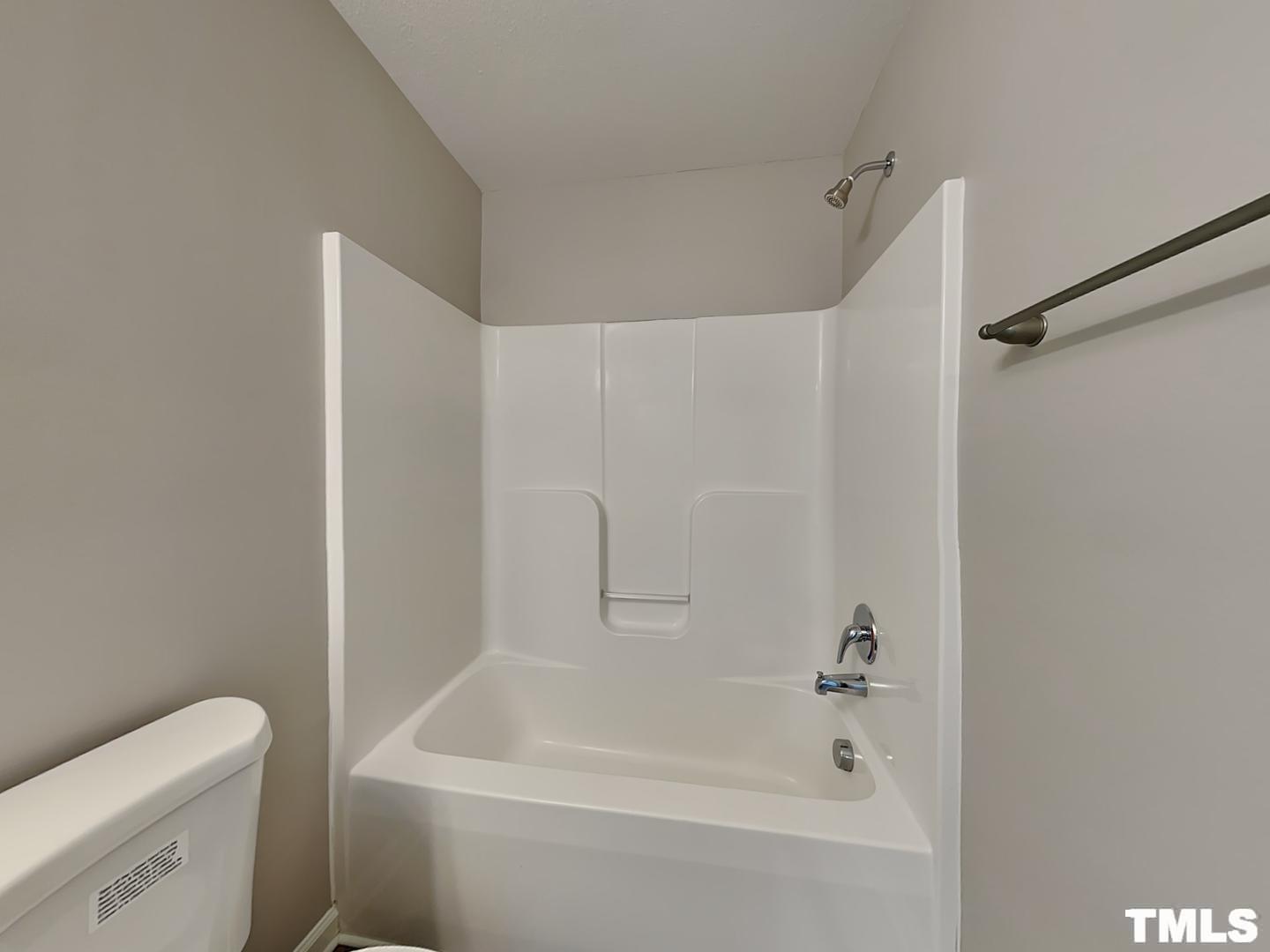 1908 Buffalo Way Durham, NC 27704 - Photo 16 of 18 a white bath tub sitting next to a white toilet and vanity