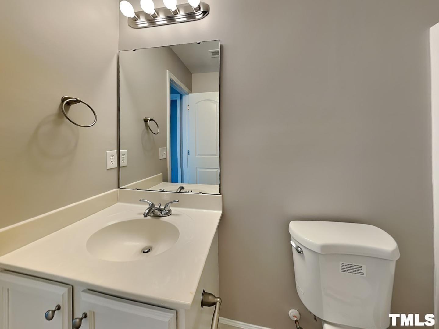1908 Buffalo Way Durham, NC 27704 - Photo 17 of 18 a bathroom with a sink and a mirror