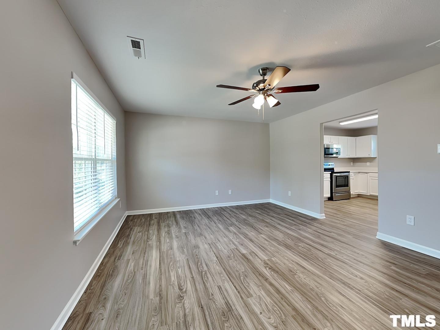 1908 Buffalo Way Durham, NC 27704 - Photo 2 of 18 wooden floor in an empty room with a window