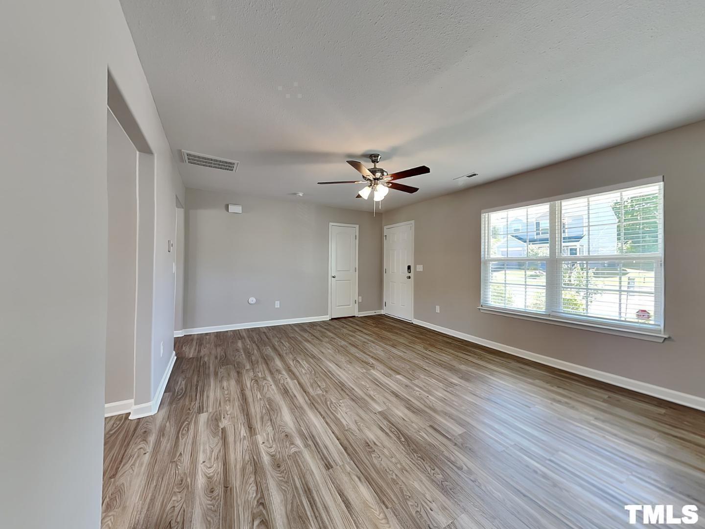 1908 Buffalo Way Durham, NC 27704 - Photo 3 of 18 wooden floor in an empty room with a window