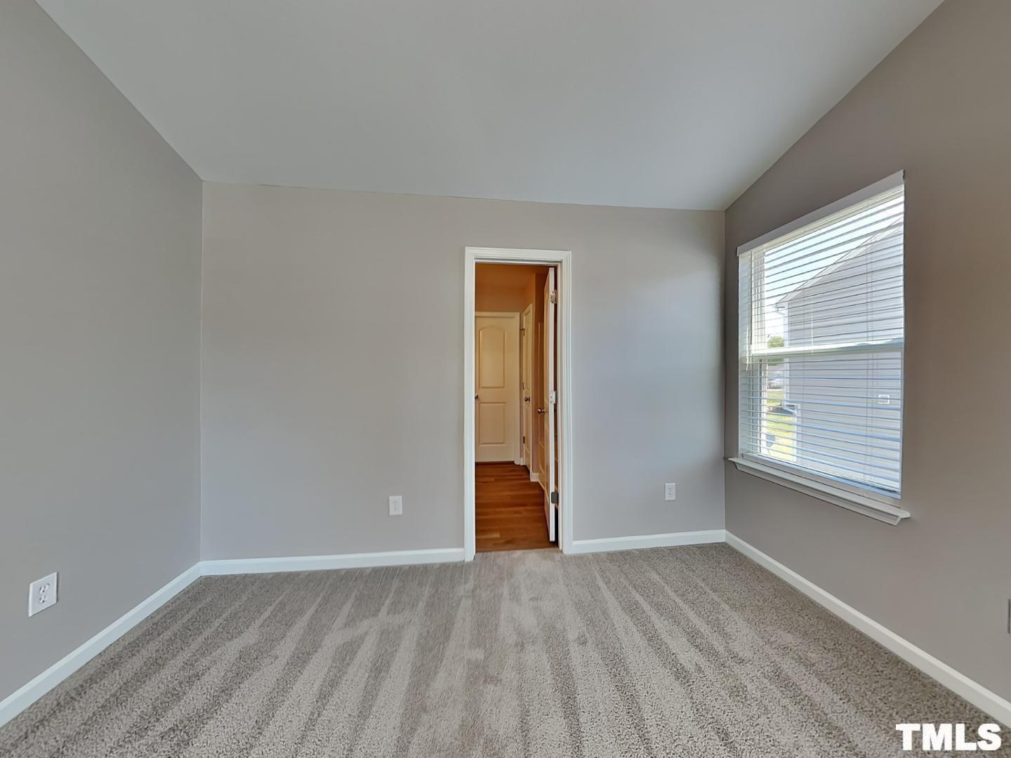 1908 Buffalo Way Durham, NC 27704 - Photo 6 of 18 a view of an empty room with wooden floor and a window