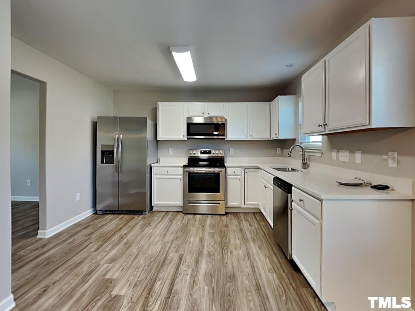 1908 Buffalo Way Durham, NC 27704 - Photo 7 of 18 a kitchen with granite countertop a refrigerator and a stove top oven