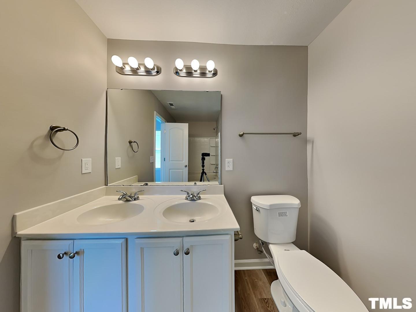 1908 Buffalo Way Durham, NC 27704 - Photo 8 of 18 a bathroom with a toilet a sink and a mirror