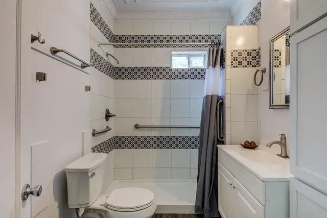 a bathroom with a toilet sink and shower