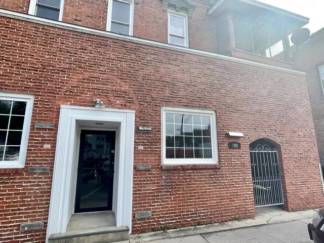 a brick house with a window and a door
