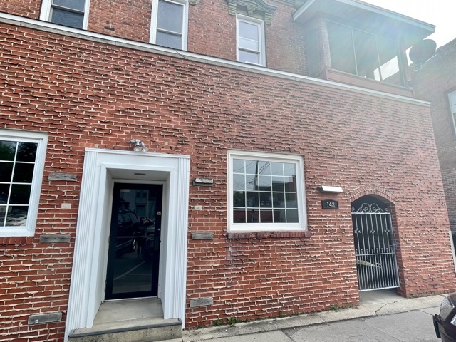 a brick house with a window and a door