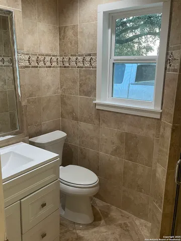 a bathroom with a toilet a sink and a shower