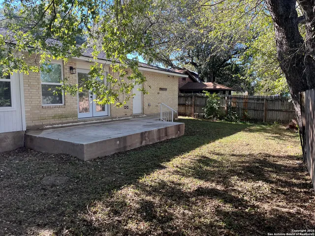 a view of a backyard with large trees