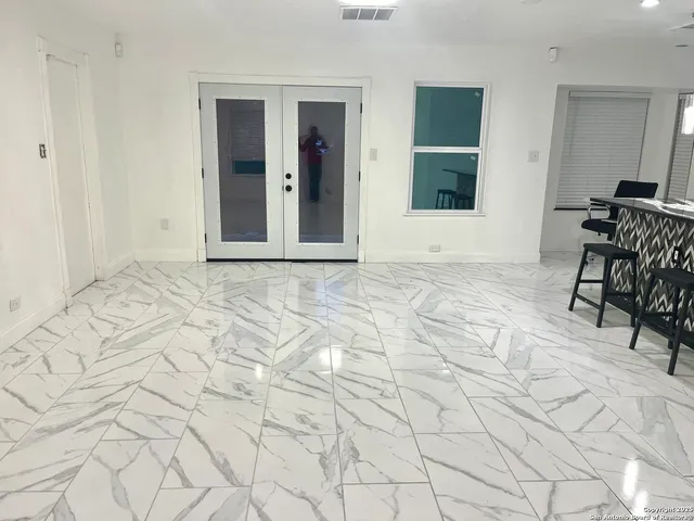 a view of a room with wooden floor and windows