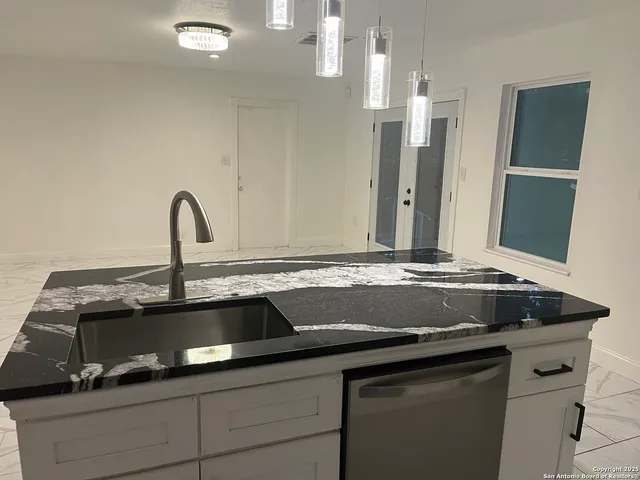 a sink with granite countertop a sink and a stove