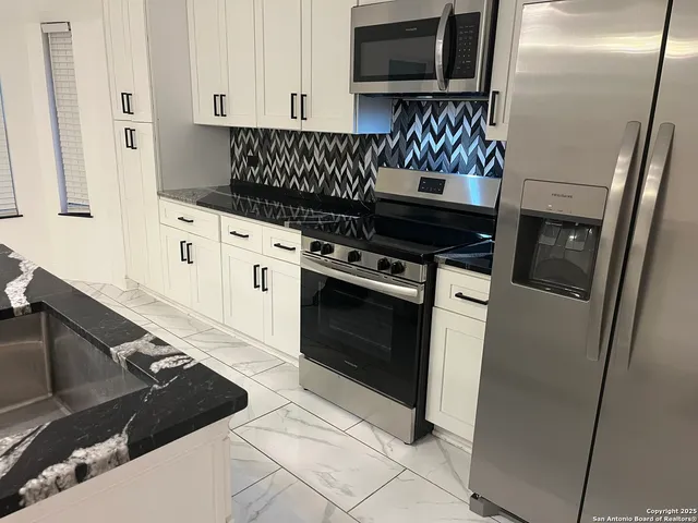 a kitchen with a stove and a refrigerator