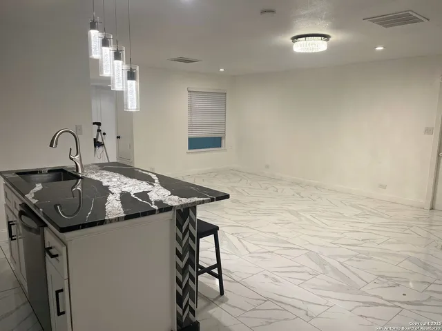 a kitchen that has a sink and a stove