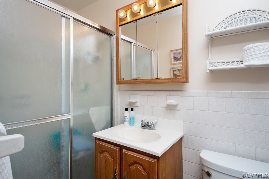 12201 Old Bailey Bridge Road Midlothian, VA 23112 - Photo 19 of 36 a bathroom with a sink a toilet and shower