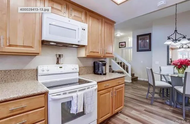 a kitchen with stainless steel appliances granite countertop a sink and cabinets