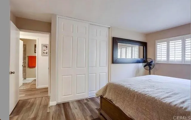 a bedroom with a bed and a mirror