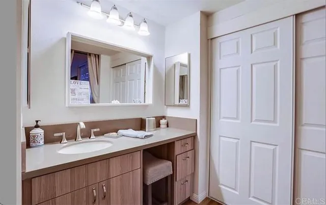 a bathroom with a double vanity sink and a mirror