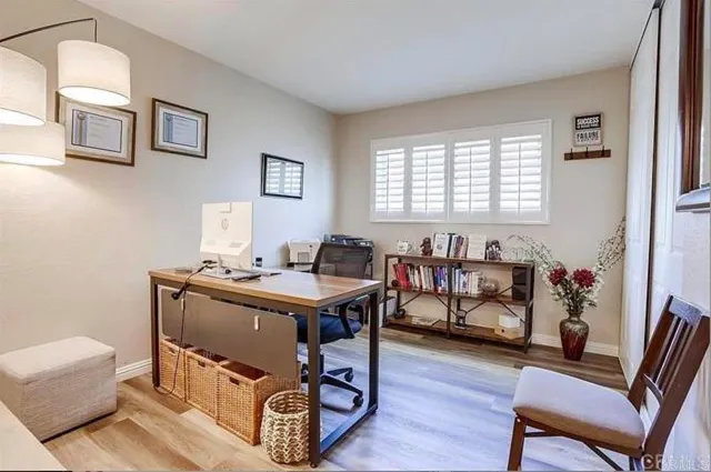 a view of a workspace with furniture and a window