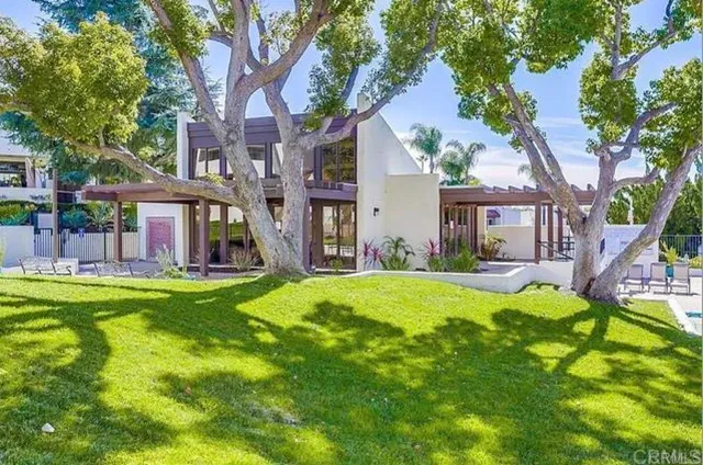 a view of a house with a yard patio and swimming pool