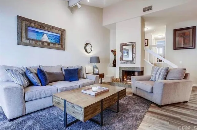 a living room with furniture a rug and a wall painting