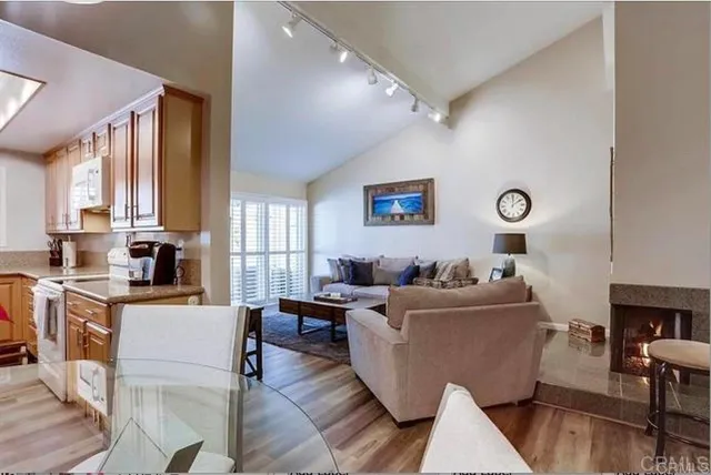 a living room with furniture wooden floor and a window