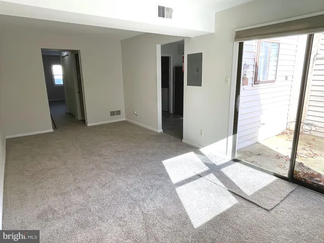 an empty room with large windows