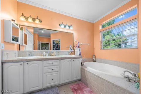 a bathroom with a granite countertop sink mirror and a bathtub