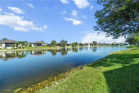 a view of a lake with houses in the back